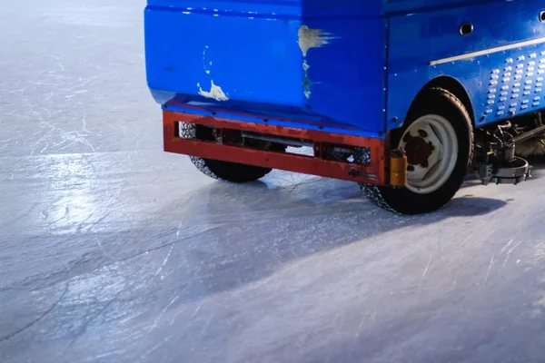 Resurfacer machine levels ice at stadium. Resurfacing