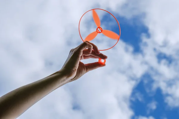 Toy propeller in hand - play with kids on outdoor in summer, toy helicopter Stock Image