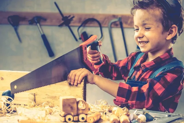 Child fathers day concept, carpenter tool,  boy workshop.