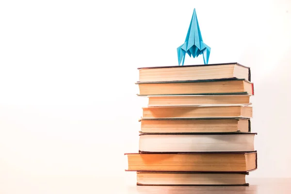 Back to school concept rocket is on books. Idea of knowledge and aspirations in a career, white background — Stock Photo, Image