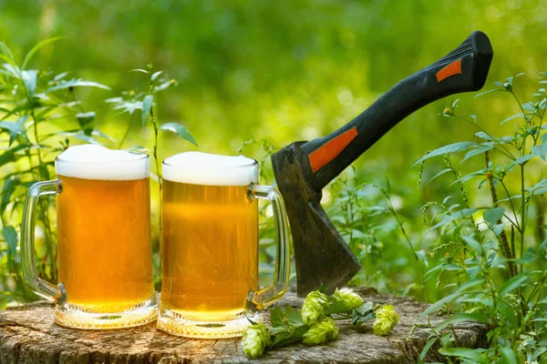 Beer mugs cheers on natural background.