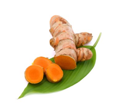 Zerdeçal yaprağında taze zerdeçal dilimleri, beyaz arkaplanda izole.