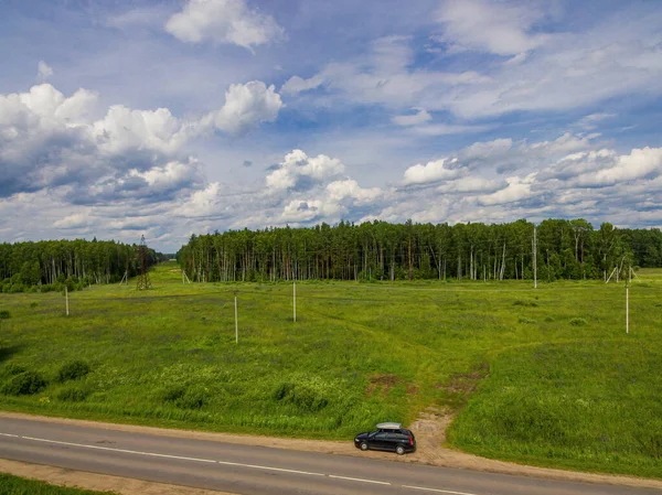 Bird\'s-eye view of the car near the forest.