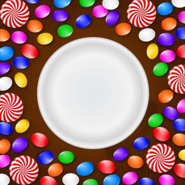 Renkli şeker, tatlılar ve lolipop. Kahverengi ahşap zemin üzerinde. Yukarıdan görüntülemek.