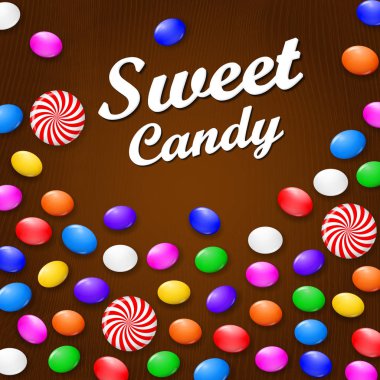 Renkli şeker, tatlılar ve lolipop. Kahverengi ahşap zemin üzerinde. Yukarıdan görüntülemek.