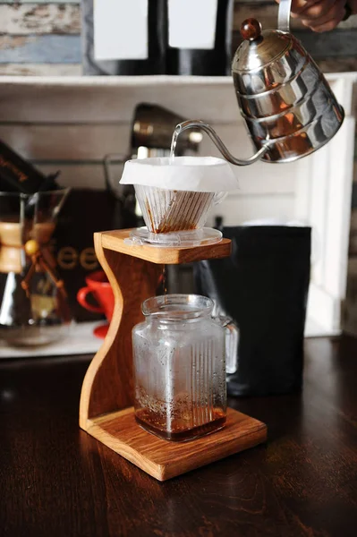 The process of coffee brewing in pour over on wooden coffee stand