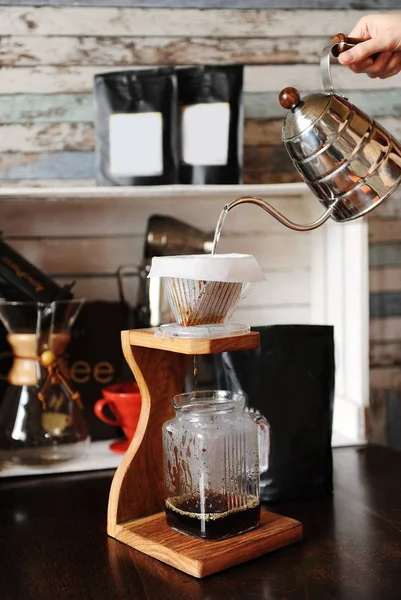 The process of coffee brewing in pour over on wooden coffee stand