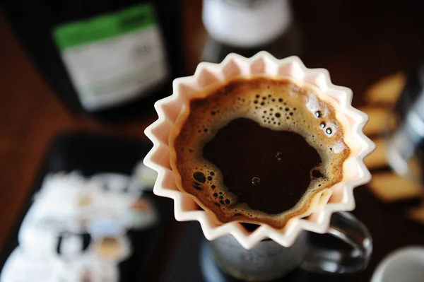 Manual alternativo de fabricação de café à mão em gotejador de origami de cerâmica rosa com filtro de papel. Fechar, vista superior — Fotografia de Stock