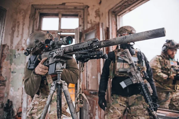 Camouflaged sniper lying in forest and aiming through his scope Stock Photo  by ©Nesterenko_Max 89112398