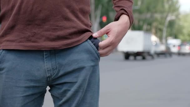 Een man zijn zak blijkt, ontdekt dat het is leeg en dan het terug draait — Stockvideo