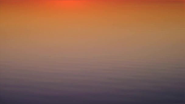 Een weergave van een plek, waar de lucht en water in lichten aan een van de zonsondergang — Stockvideo