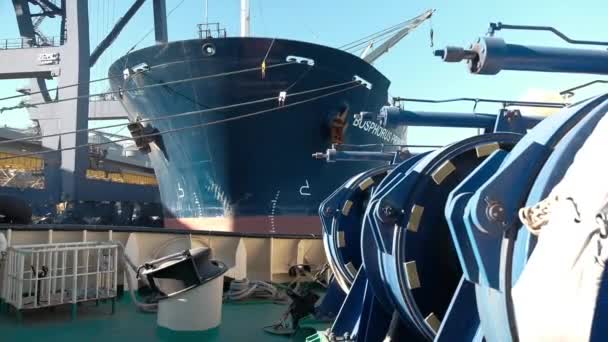 Odessa, Ukraine, October 20, 2018. Winch tug on the background of a large merchant ship at the pier — Stock Video