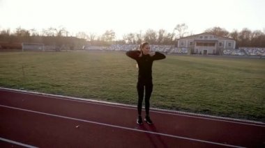 Kız bir koşu bandı üzerinde fitness egzersizleri gerçekleştirir.