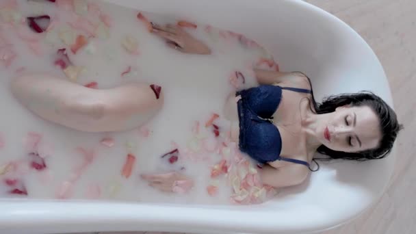 Girl in underwear takes a bath with milk and rose petals — Stock Video