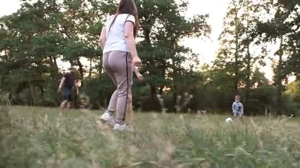 Family soccer team game among nature. — Stock Video