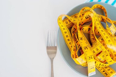 Diyet kavramı. Çatalı tabağa yalan santimetre rewound
