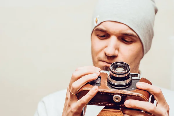 portrait of stylish handsome man with old fashioned camera