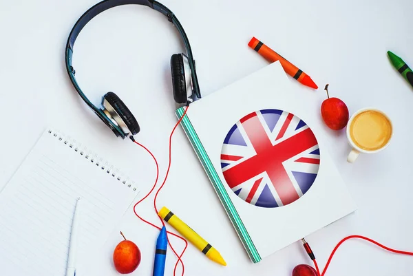 the book with british flag and headphones. concept of english learning through audio courses