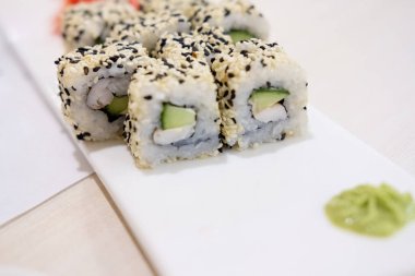Karidesli suşi, avokado, krem peynir ve susamlı. Suşi menüsü. Japon yemeği..