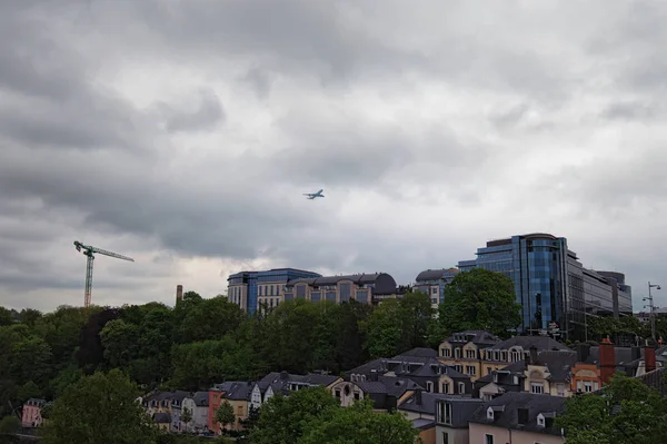 Cloudy spring morning in Luxembourg City. Downtown city, scenic view to the park and buildings. the plane is flying over the residential area of Luxembourg, Grand Duchy of Luxembourg.