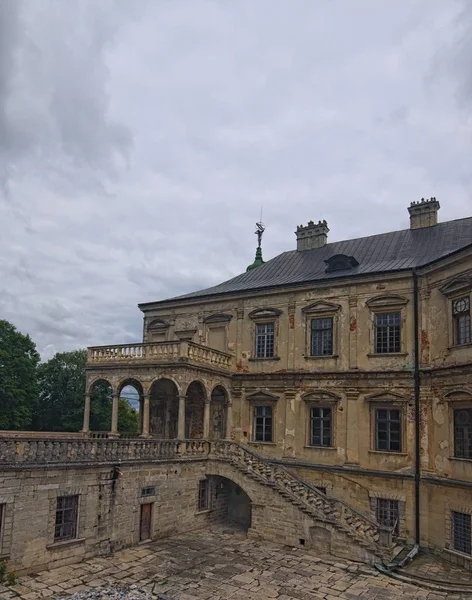 Ancient Pidhirtsi Castle at cloudy summer day. Beautiful stairs to the open terrace of the castle. Village Pidhirtsi, Lviv region, Ukraine.