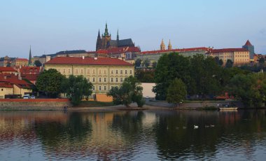 Prag Kalesi ile Saint Vitus Katedrali Prag kuğular yüzme ile Vltava Nehri tarafından tarihi şehir merkezinde doğal görünümünü. Prague, Çek Cumhuriyeti.