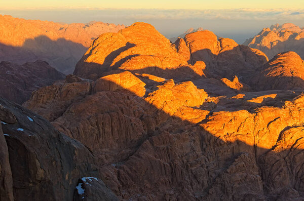 Scenic landscape of mountain peaks during sunrise. Sinai Mountain (Mount Horeb, Gabal Musa, Moses Mount). Sinai Peninsula of Egypt. Pilgrimage place and famous touristic destination.