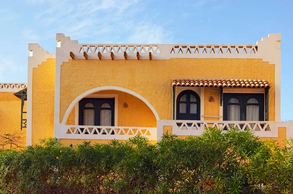 Yellow two-storey hotel building in the Arabic style. Tourist resort near the Red Sea. Summer vacation concept. Sinai peninsula, Sharm Al Sheikh, Egypt.