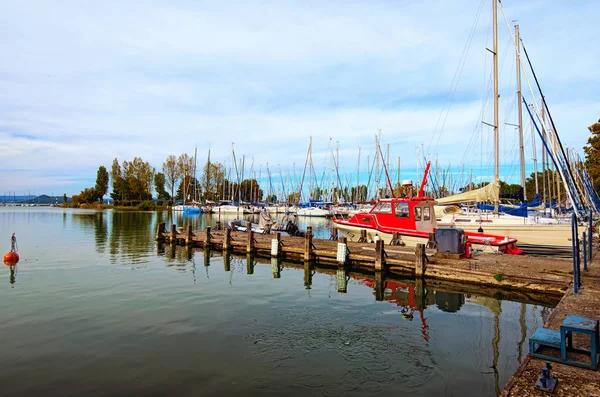 Stunning autumn landscape view of sailboats and small yachts anchored in Balatonfoldvar at Lake Balaton, Hungary. Famous touristic place and romantic travel destination