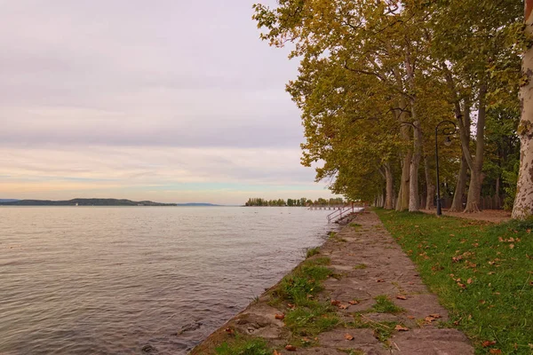 Hermosa vista panorámica del callejón de los plátanos en el lago Balaton durante el atardecer. Famoso lugar turístico y destino turístico romántico en Balatonfoldvar, Hungría —  Fotos de Stock