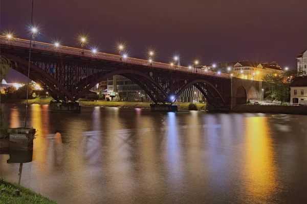Vista noturna da paisagem da Ponte Velha iluminada (também chamada de Estado) sobre o Rio Drava. Destino de viagem popular em Maribor, Slovenia — Fotografia de Stock