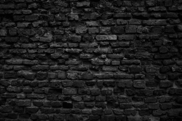 Old black brick wall. Grunge background
