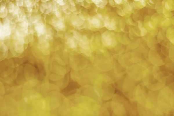 抽象的な金ライトボケクリスマスライトぼやけた背景 — ストック写真