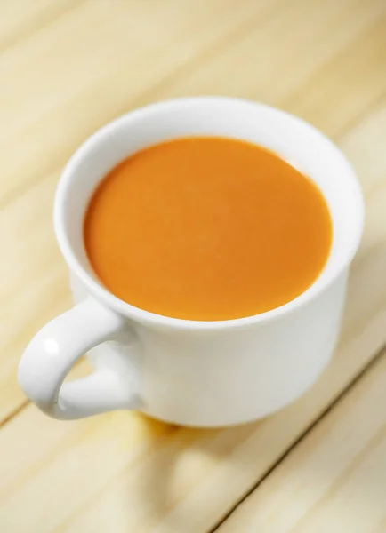 Hot milk tea in a white cup on wooden — Stock Photo, Image