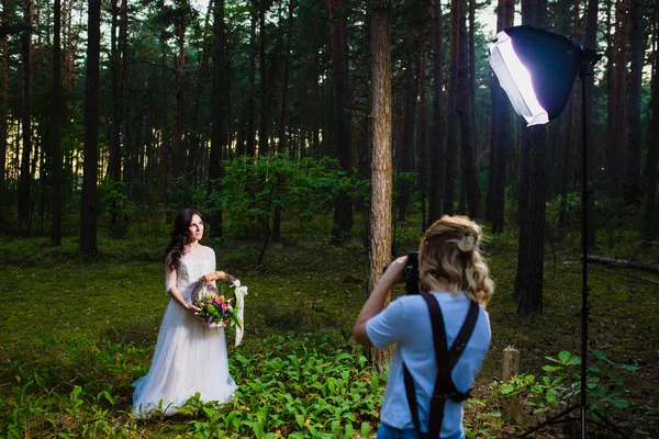 Professional wedding photographer using strobe and softbox to make pictures