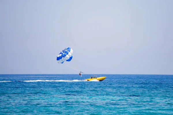 Coppia di turisti vola su un paracadute blu e bianco — Foto Stock