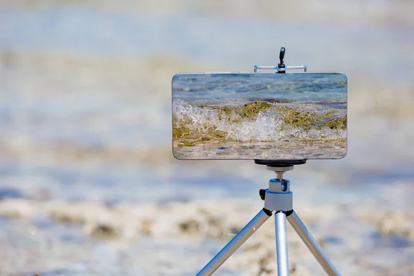 Smartphone haciendo fotos y videos cerca del borde del mar — Foto de Stock