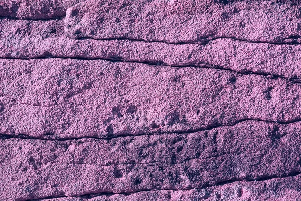 Texture of weathered stone, tinted in violet