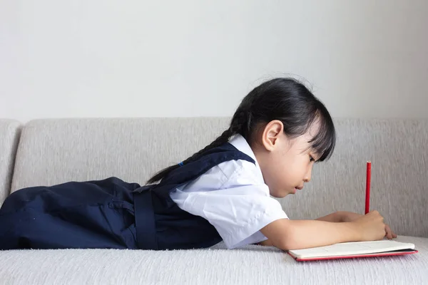 Asian Chinese Little Girl Laying Sofa Writing Book Living Room — Stock Photo, Image