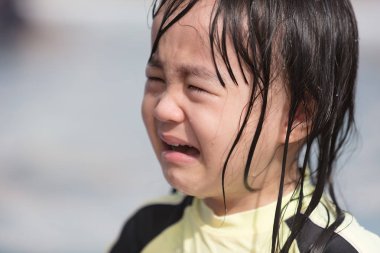 Asian Little Chinese Girl crying in Swimming Pool outdoor clipart