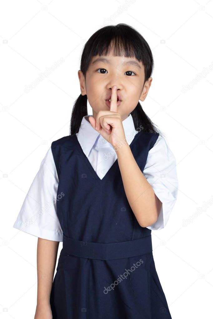 Asian Little Chinese Girl putting finger up to lips and asking for silence in isolated White Background