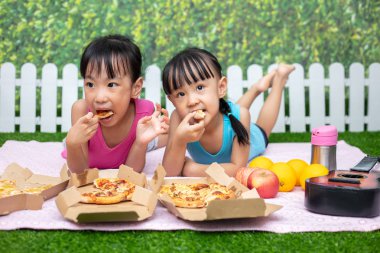 Asyalı Çinli küçük kız açık Garden'da pizza yemek