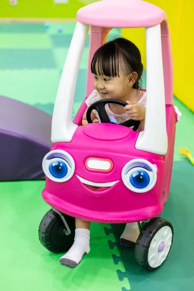 Asian Chinese Little Girl Driving Toy Car Indoor Playground — Stock Photo, Image