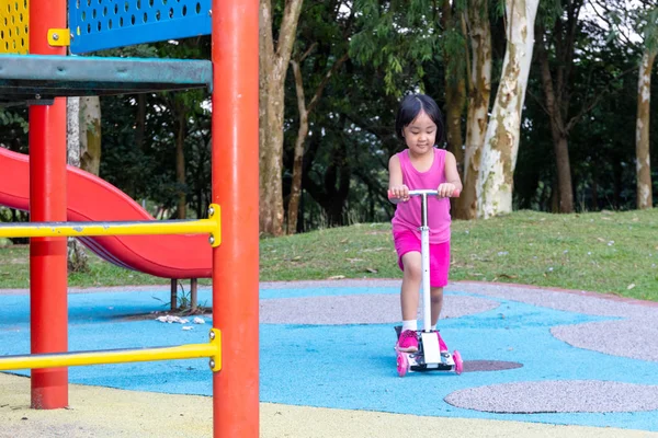 Ασιατικές μικρή κινεζική κορίτσι παίζει με σκούτερ — Φωτογραφία Αρχείου