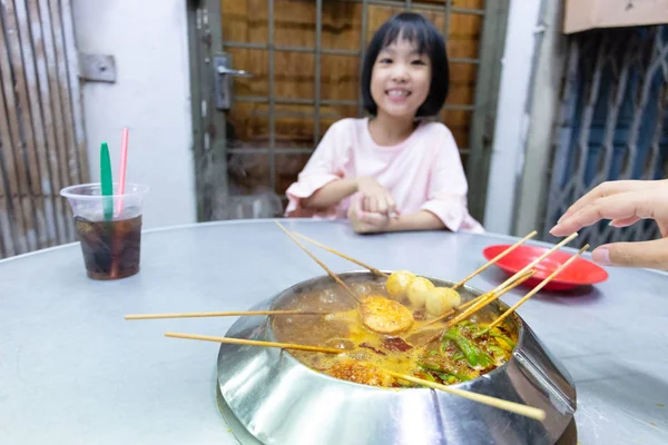 Asiática poco china chica comer caliente pot en un restaurante — Foto de Stock