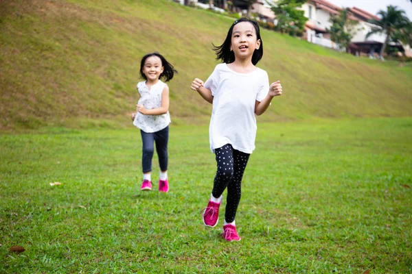 Asian Little Chinese Sisters running happily Stock Photo