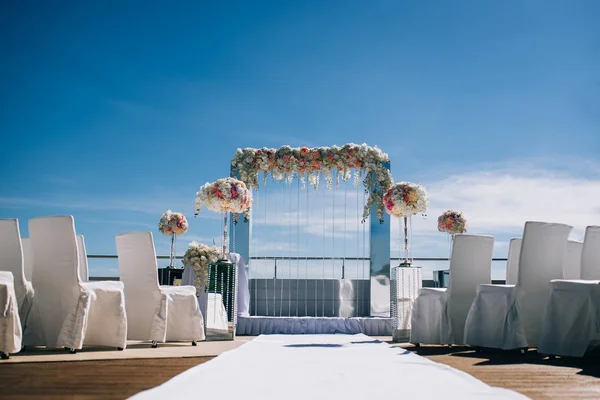 wedding decorations from flowers and a wedding arch for the ceremony