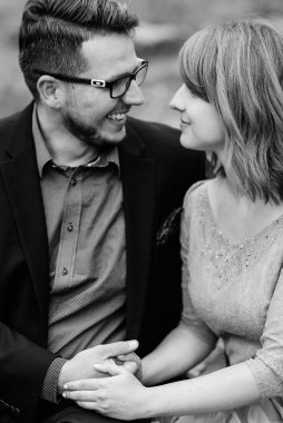 Genç bir çift göl kenarında yürüyüş yapıyor. Etrafı Karpat dağlarıyla çevrili.