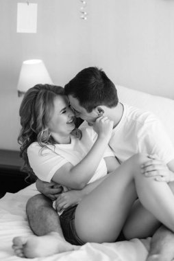 Genç çift sabah gelin ve damat bir otel odasında birlikte günün tadını çıkarıyorlar.