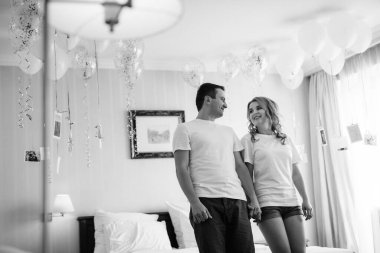 Genç çift sabah gelin ve damat bir otel odasında birlikte günün tadını çıkarıyorlar.